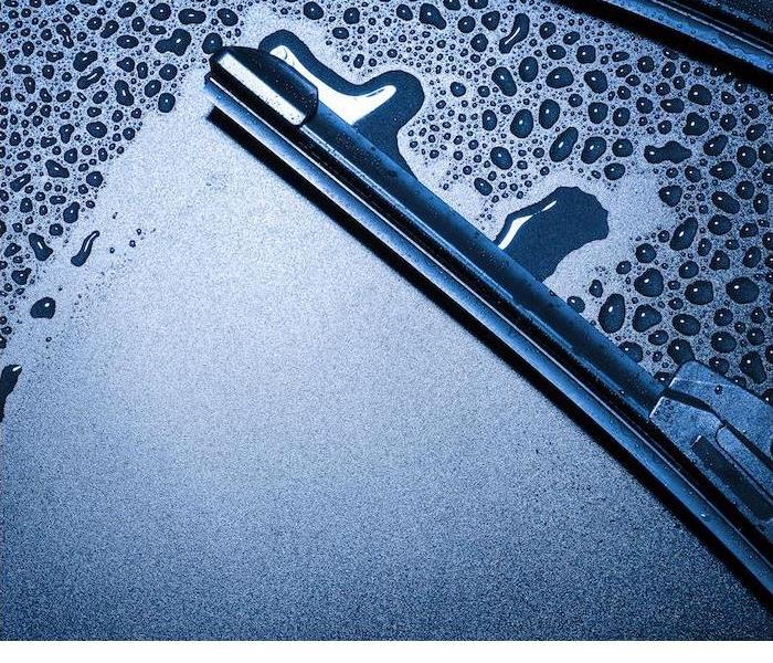 A close-up image of a wiper blade wiping away condensation on a car windshield